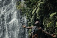 Koteka tradisional suku Papua dengan latar pegunungan Jayawijaya